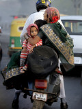 Family Rides on a Two-Wheeler in New Delhi, India