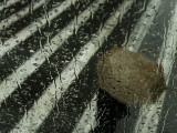 Sheltering Under an Umbrella as He Walks Along a Street During a Rain Storm in Central Athens