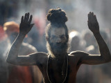 Naked Hindu Holy Man Performs Rituals on Banks of River Ganges During the Kumbh Mela in India