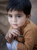 Boy Waits to Receive a Ration of Donated Rice at Food Distribution Center in Islamabad, Pakistan