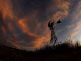 Buy Old Windmill is Silhouetted Against Clouds Colored by the Setting Sun at AllPosters.com