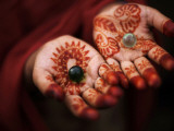Pakistani Girl Displays Her Hands Painted with Henna Paste
