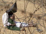 Buy Iraqi Prisoner of War Confort His 4-Year-Old Son at a Regroupment Center for POWs Near Najaf at AllPosters.com