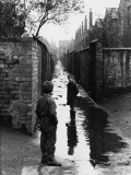 Two Boys Playing in a Large Puddle - Manchester, 1966