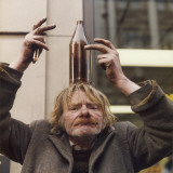 Tramp Balancing a Beer Bottle on His Head