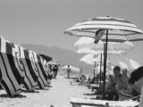 Sunbathers under Striped Parasols - Kos