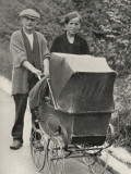A Beggar Couple with a Child in a Pram. the Pram Has No Tyres