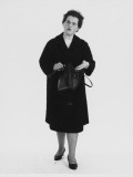 Full-Length Portrait of a Woman Who's Discovered Something Missing from Her Handbag