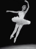 Ballerina Margot Fonteyn in White Costume Leaping into the Air While Dancing Alone on Stage