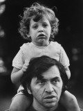 Bill Graham Carrying His Young Son David on His Shoulders Outside Home