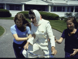 Matriarch Rose Kennedy Riding Bicycle with Help from Granddaughters at Hyannis Port Compound