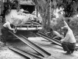 Unloading the New Ford Car, Swathed in Canvas, to Make Advertising Pictures of the New Model