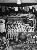 Housewife Marjorie McWeeney Ironing Amidst Display of Her Week's Housework at Bloomingdale's