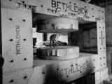 Man Inspecting Machinery Used to Forge a Large Magnet Which Will Be Used in a Cyclotron