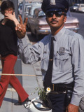 Policeman Flashing Peace Sign During Anti-War Demonstration