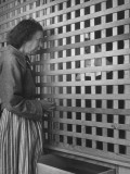Painter Lauren Ford Talking to Nun Through Wooden Grill