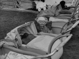 Buy Baby Sitting in Baby Carriage at AllPosters.com