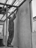 Man Hammering Bean to Stud