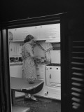 Woman Pouring Drinks in Her Kitchen of Her Trailer