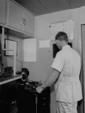 Buy Doctor Looking Through Window While Operating X-Ray at AllPosters.com