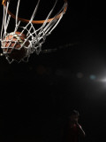 Young Man Playing Basketball (Focus on Hoop in Foreground)
