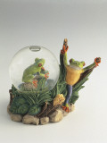 Close-Up of a Frog's Figurines with a Snow Globe