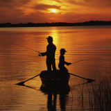 Silhouette of Father and Son Fishing at Sunset