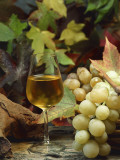 Close-Up of a Glass of White Wine with a Bunch of Grapes