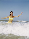 Retro Woman Laughing and Splashing in Beach Surf