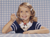 Girl Smiling Eating an Ice Cream Sundae