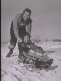Buy Girl Pushes Child on Sled with Christmas Gifts at AllPosters.com