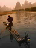 China, Guangxi Province, Yangshuo, Fisherman Fishing with Cormorants on Bamboo Raft on the Li River