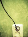 A Cable Plugged in a Socket in a Green Wall Photographic Print