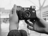 Person Taking Self-Portrait with Vintage Camera