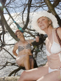 Two Senior Women Relaxing, Sitting in a Tree by a Lake in Uppsala, Sweden