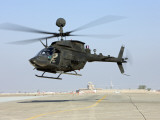 Buy An Oh-58D Kiowa Warrior Hovers over the Flight Line at Camp Speicher, Iraq at AllPosters.com