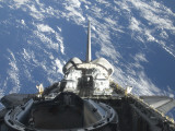 Buy A Partial View of Space Shuttle Atlantis Backdropped by a Blue and White Earth at AllPosters.com