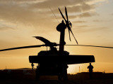 A UH-60L Black Hawk Helicopter Silhouetted by the Setting Sun