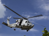 Buy A Crew Chief Looks Out the Side Door of a Helicopter in Flight at AllPosters.com