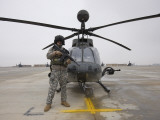 Buy An Oh-58D Kiowa Warrior Pilot Stands Beside His Aircraft at AllPosters.com