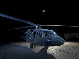 Buy A UH-60 Black Hawk Helicopter Parked on the Flight Line under a Full Moon at AllPosters.com