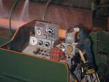 A Worker Services a Television Monitor That Tracks Steel Production