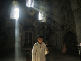 Buy An Altar Boy Holds a Candle Inside a Dimly-Lit Church at AllPosters.com
