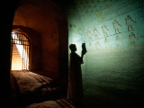Buy A Man Illuminates Hieroglyphics on a Wall in a Nubian King's Tomb at AllPosters.com