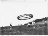 A Wheel-Shaped Kite Flies as its Inventor, Alexander G Bell, Watches