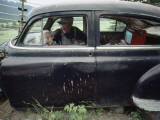 Buy A Mother and Son Watch Television in an Old Car at AllPosters.com