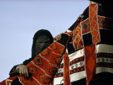 A Veiled Bedouin Woman Peers Through a Slit-Eyed Veil