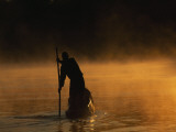 Buy A Man Poling a Dugout Canoe on the Zambezi River at Twilight at AllPosters.com
