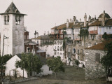 Buy A White Bell Tower Stands Bright Against the Red Katholikon at AllPosters.com