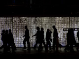 Pedestrians Walk in Front of a Light Display in Las Vegas